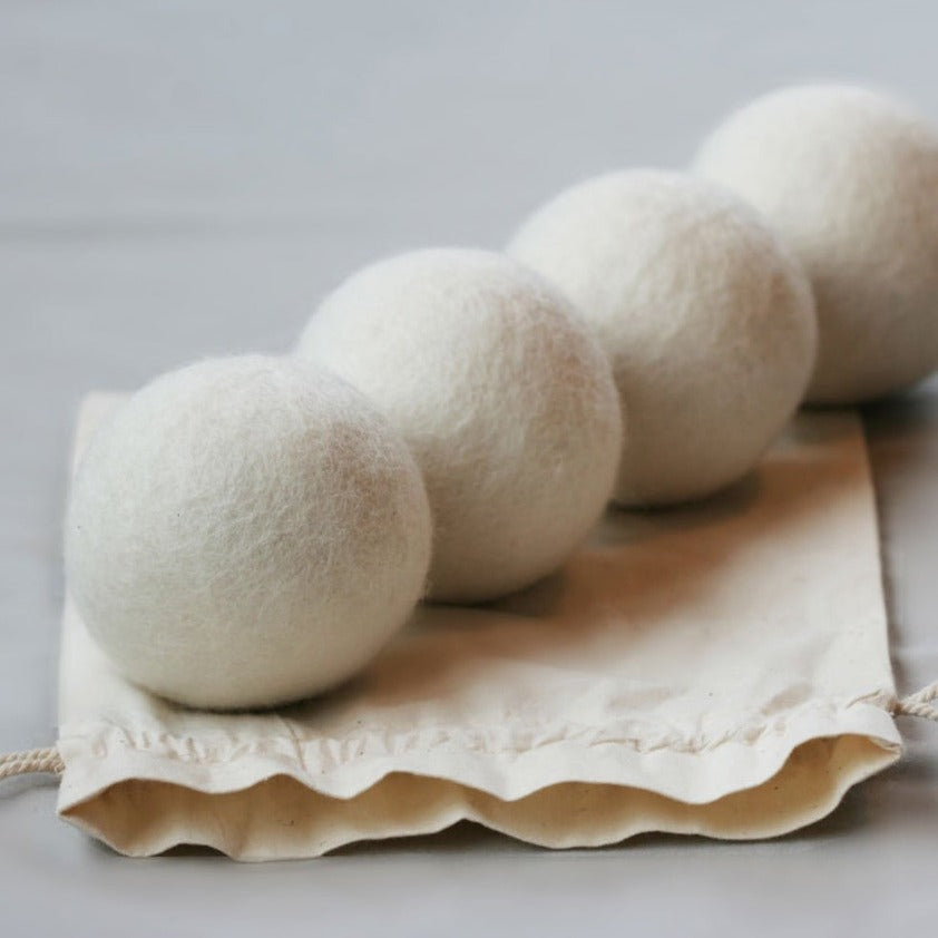 four NZ Wool Dryer Balls on cotton bag