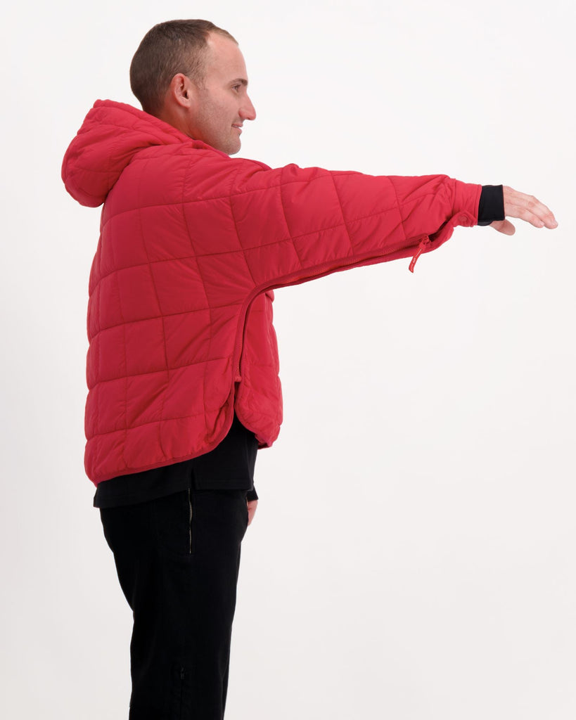 Standing male is wearing a magenta red puffer jacket over black pants. Christina Stephens Adaptive Clothing Australia.