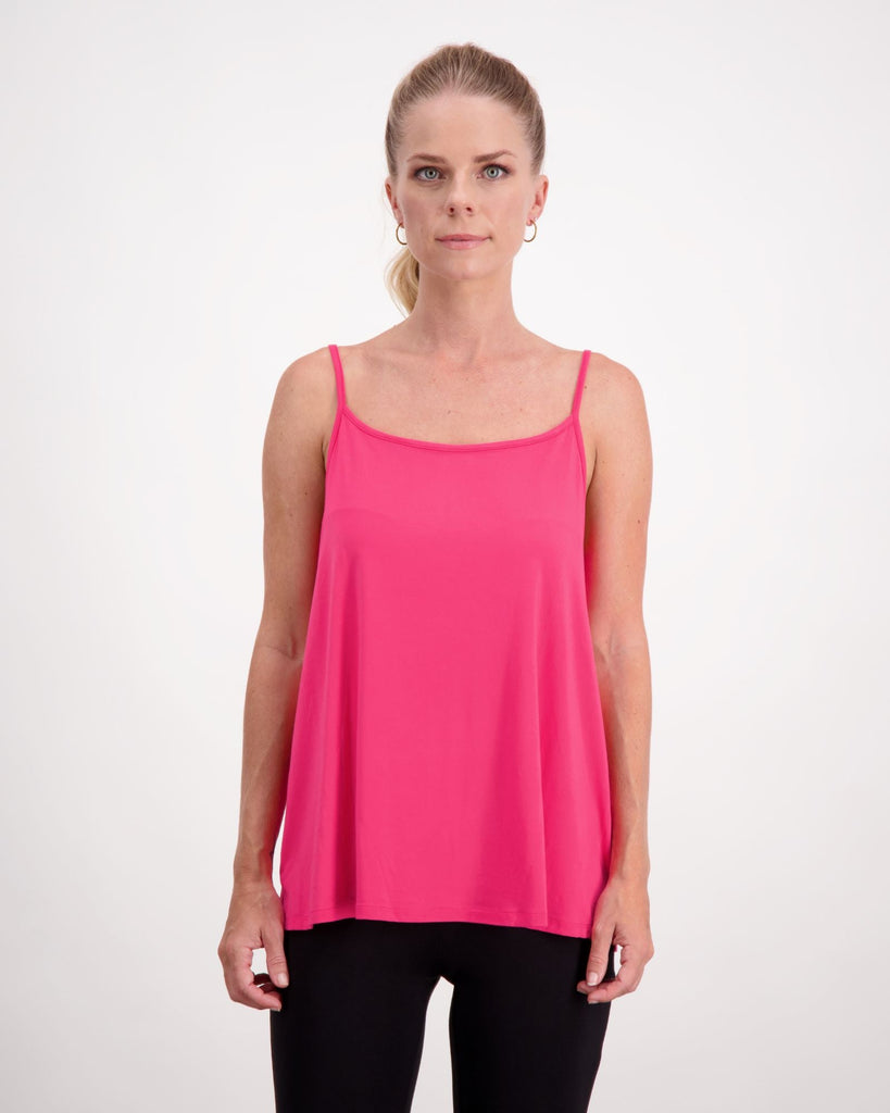 Blonde woman wearing a pink camisole top and black pants. Christina Stephens Adaptive Clothing Australia. 