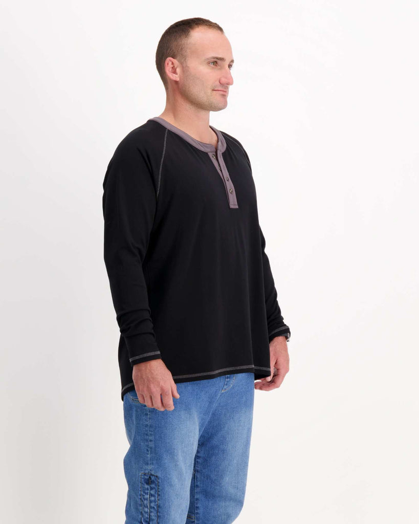 Standing male is wearing a bamboo long sleeve raglan style t-shirt with jeans. Christina Stephens Adaptive Clothing Australia.