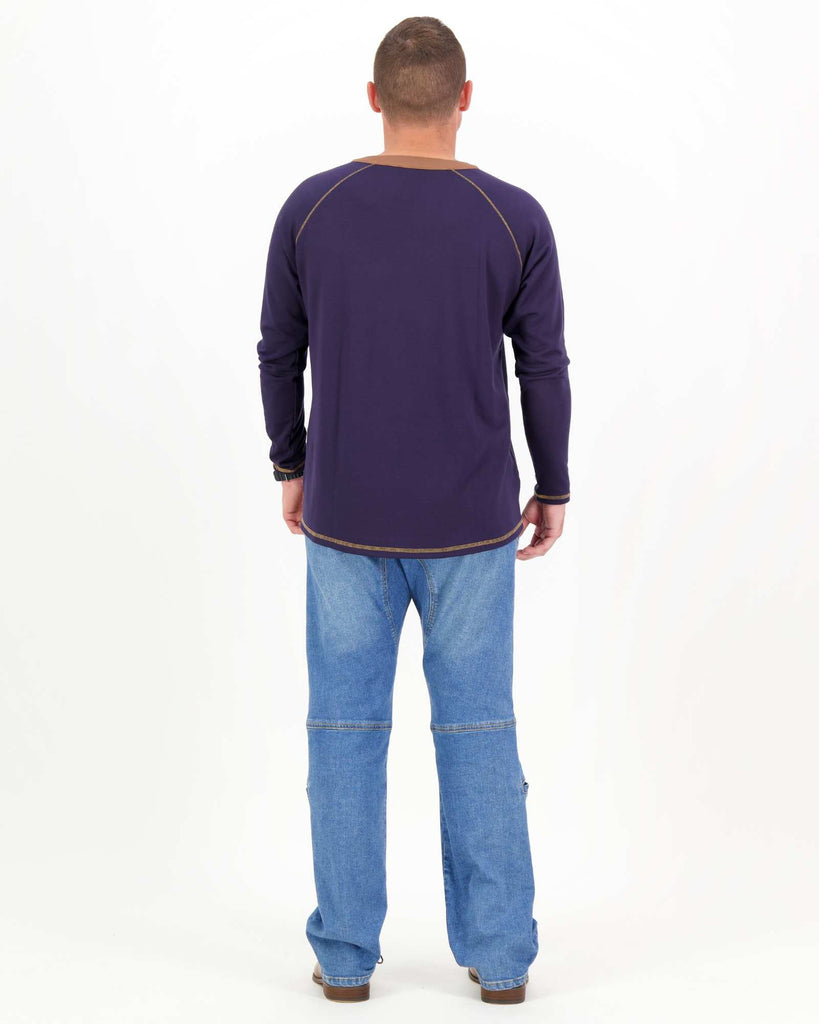 Standing male is wearing a bamboo long sleeve raglan style t-shirt with jeans. Christina Stephens Adaptive Clothing Australia.